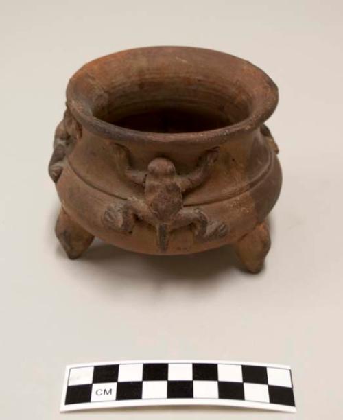 Ceramic Tripod vessel, three frog appliques on exterior below rim