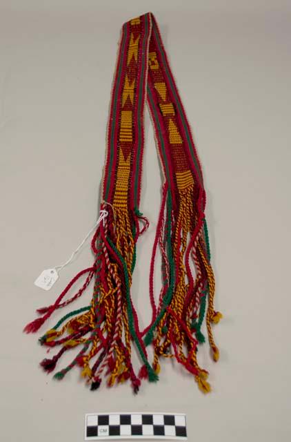 Belt, red with green and orange, fringe at ends