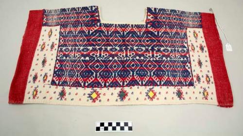 Huipil, woman's shirt, short, white with red borders and dense pink and dark blue geometric designs around neck