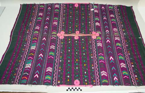 Huipil, woman's shirt, dark green with pink bands and medallions at neck and edges, pink, purple, blue and light green geometric designs