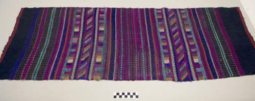 Huipil half, woman's shirt, dark blue multicolored bands and geometrics in magenta, purple, white, orange, blue, and brown