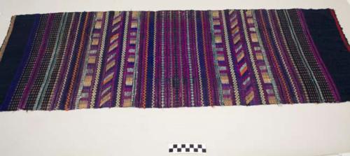 Huipil half, woman's shirt, dark blue multicolored bands and geometrics in magenta, purple, white, orange, light blue, and brown