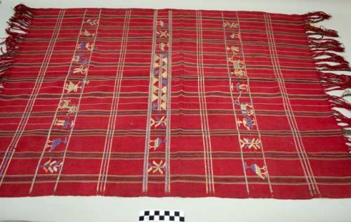 Tzute, women's multipurpose cloth, red cotton, with multicolored stripes and silk humans, birds, and floral images, fringes at both ends