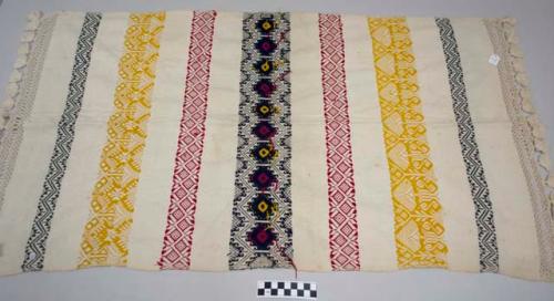 Tzute, women's multipurpose cloth, white cotton with bands of multicolored geometric designs, macrame tassels on both ends