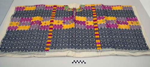 Huipil, large women's shirt, white cotton with a decorated top half of thick horiztonal bands of  multicolored geometric designs, floral embroidery at neck and decorative randas connecting panels