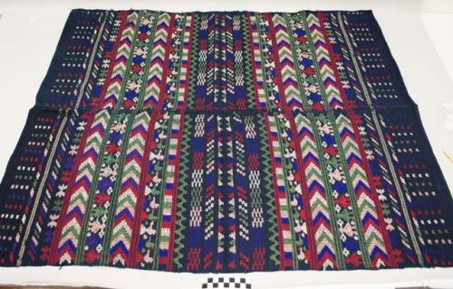 Huipil, women's shirt, two panels sewn together, no head hole, indigo cotton with multicolored geometric and anthropomorphic designs