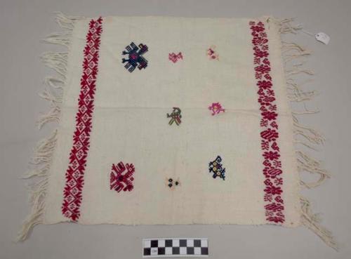 Servilleta, small multipurpose cloth, white with bands of red designs at each end and multicolored zoomorphic images, fringed