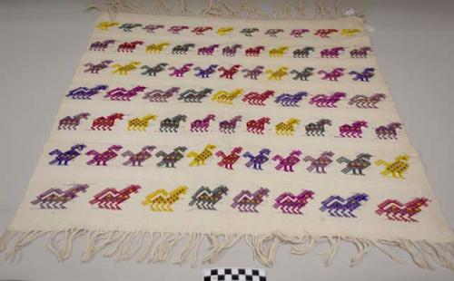 Tzute, multipurpose cloth, white with multicolored animals in horizontal bands across surface, fringed at both ends