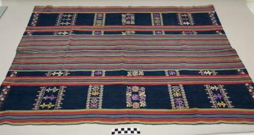 Tzute, women's multipurpose headcloth, two pieces sewn together, indigo with multicolored stripes in the middle and on the edges, multicolored floral and geometric images.