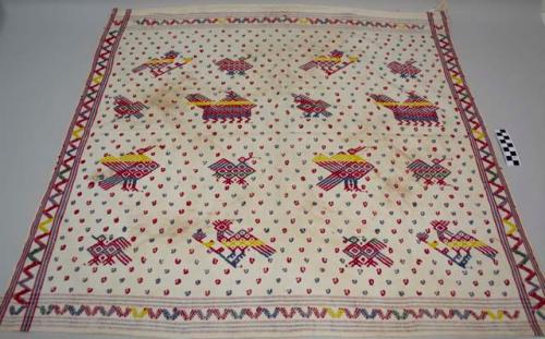 Tzute, women's multipurpose headcloth, white with red and blue stripes and birds, animals, geometrics, and dots; stained