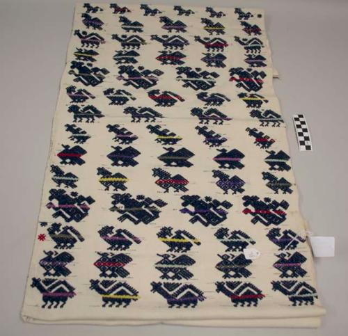 Huipil, two panels, no head hole, white with dark blue and multicolored animals