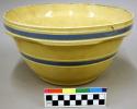Ceramic mixing bowl. yellow glaze with blue and white horizontal stripes around