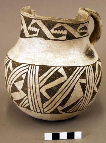 Jar, single lug, large rim sherd missing, black on white geometric design exteri