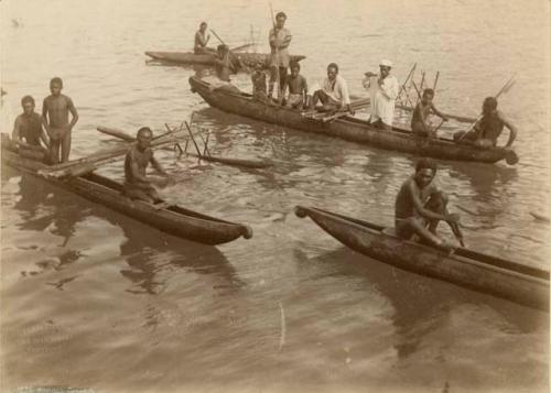 Men and Boys in Four Canoes