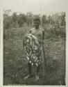 Photo of an Aboriginal Queensland Warrior holding a rainforest style shield, a spear and a spearthrower