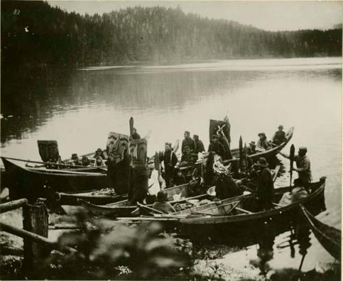 Quatsino wedding. Many people in canoes singing songs.