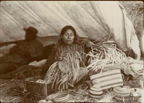 Woman weaving basket. Wakashan Indians