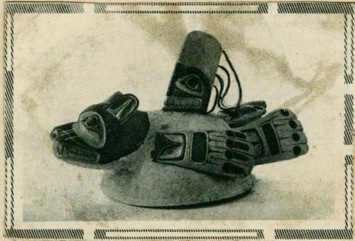 News clipping showing a carved and painted ceremonial wooden hat