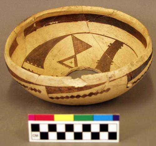 Black on yellow pottery bowl, restorable?