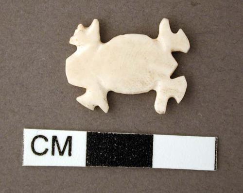 Shell, carved effigy, animal with four legs, flat