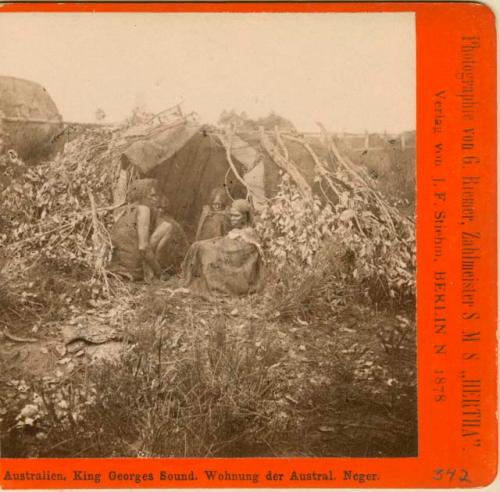 Aboriginal women huddled in a shelter