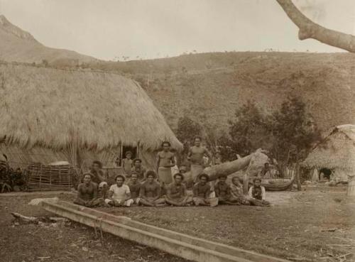 Large group of native people in village clearing