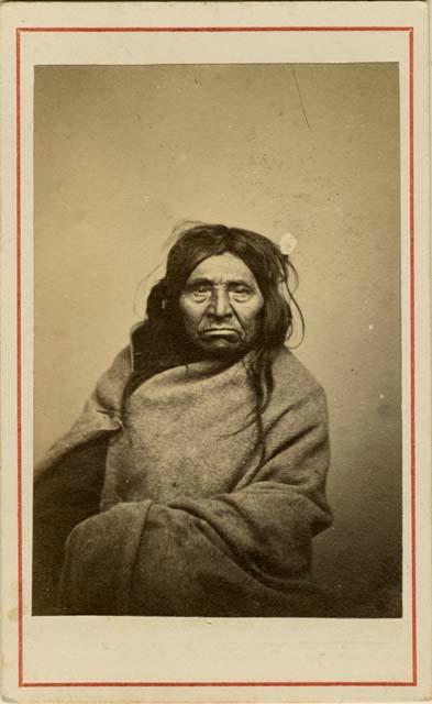 Studio portrait of woman wrapped in blanket