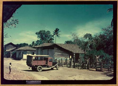 Truck and child in street in front of Samuel K. Lothrop's house