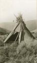 Woman's tepee of poles and fur brush covered with mats