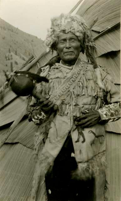 Thompson River Indian (Salishan) man "Roi.pellst" (Flaming Stone) in front of tepee, near Spences Bridge