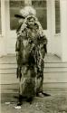 Thompson River Indian (Salishan) man "Kwel kwelstculem" (Red Buffalo Bull) in costume of chief's bonnet of eagle feathers