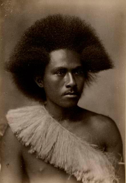 Studio portrait of a Fijian man wearing a sash made of plant fiber