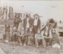 Group of ten men and women, and one child, sitting and standing for picture