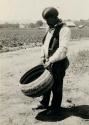 Charlie Williams, holding large basket