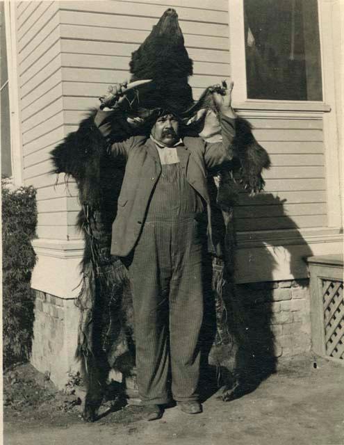 William Benson modeling a Pomo bearskin disguise now in the Peabody Museum