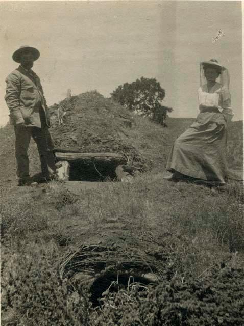 Grace Nicholson and William Benson(?) standing at a Sulphur Bank Sweat House