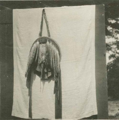 Round Apache shield with long feathers attached