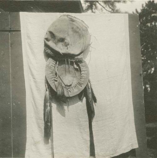 Round Apache shield with long feathers and circular attachment