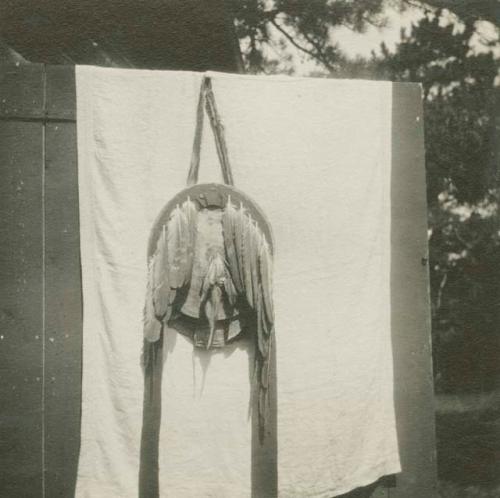 Round Apache shield with long feathers attached