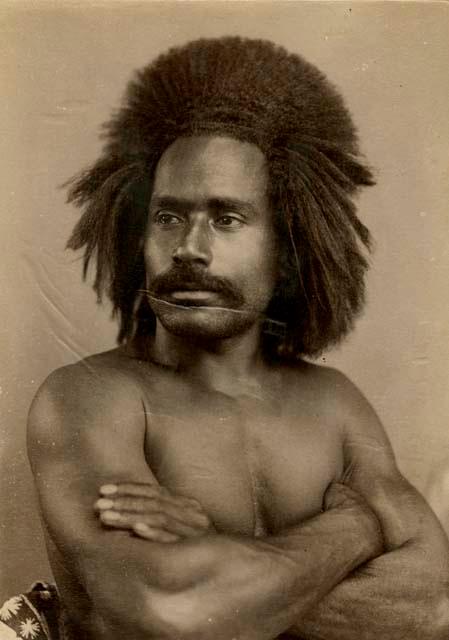 Studio portrait of a Fijian man, arms crossed