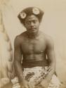 Studio portrait of a Fijian man wearing a beaded choker and flowers in his hair