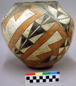 Polychrome jar. Black and orange on white. Geometric design elements