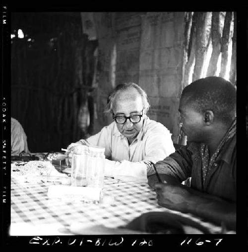 Kernel Ledimo sitting with Charles Koch at a table