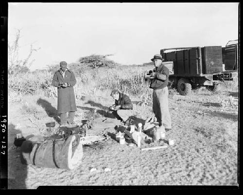 John Marshall, Edward Hartley and Laurence Marshall eating in the expedition camp