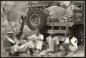 Left to right, David Venter, Ngani, Carl Lowe (or Louw), John Marshall, Petrus, and Koho
 sitting by truck