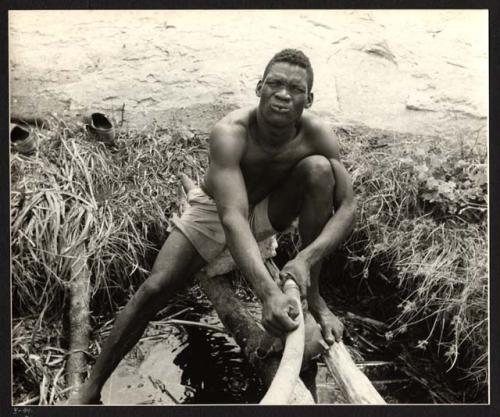 Expedition member pumping water from the waterhole at Gautscha, believed to be Mbuenga Garu