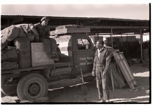 Kernel Ledimo and Heinrich Neumann standing in front of an expedition truck