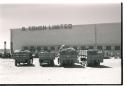 Expedition trucks parked in front of a building