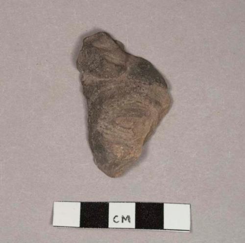 Fragments of faces from 3-handled pottery suspension bowls