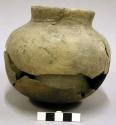 Ceramic jar, short straight neck , sherds missing from body.